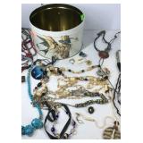 Round tin with costume jewelry