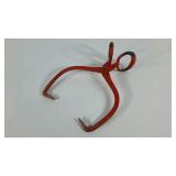 Ice tongs, red paint peeled in spots