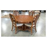 Round 60" dining table with four chairs, some