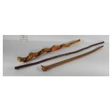 Three wooden walking sticks, one twisted wood,