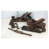 Three wood planes and a vise clamp