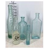 Five glass bottles, one is coca-cola Staunton