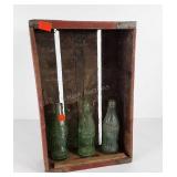 Coca-Cola soda crate with three bottles,