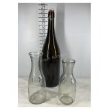 Two dairy bottles and a large wine bottle seller