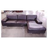 Leather look sofa with lounger, exposed staple on