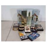 Five wine bottle tins and seven VHS tapes