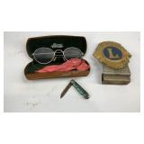 Eye glasses, pocket knife, and lions
