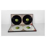 Four Beatles vinyl record albums in frames, each