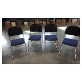 Four stackable chairs,  tubular aluminum frames,