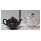 Two tea pots, cat and flowers