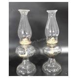Two clear glass oil lamps