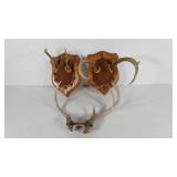 Three sets of antlers, two on wall plaques