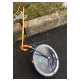 Roll a Tape Measuring Wheel, rolls out 4ft for a