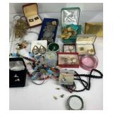 Jewelry in plastic container, rings, necklaces,