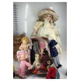 Several dolls and a teddy bear statue