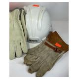 Two hard hats and three pairs of work gloves