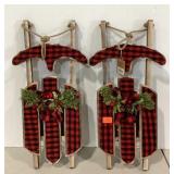 Two lighted  plaid holiday sled wall hangings,