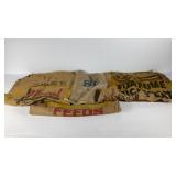 Four burlap bags to feed, one peat and smaller