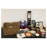 Basket filled with frames, towel rod, plates,