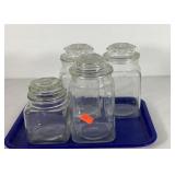 Four glass canisters