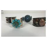 Four cuff bracelets with stones