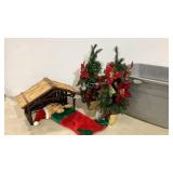 Holiday trees, stable and stocking in tote