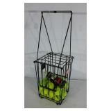Tennis ball caddy with supply of tennis balls.