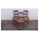 Three cane seat chairs, carved detail, damage as