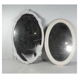 Two white framed oval mirrors, one wood, one