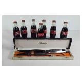 7 Coca-Cola bottles and a carving knife set