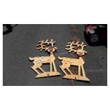Two wooden reindeer lawn ornaments
