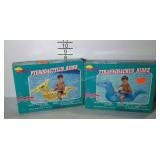 Two inflatable dinosaur ride-on toys. One