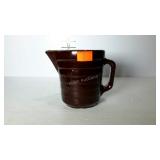 Smaller stoneware pitcher with brown glaze.
