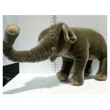 Large tightly stuffed elephant, missing tusks.