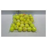 Approximately 35 yellow golf balls, assorted