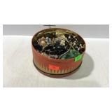 Tin of costume jewelry