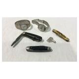 Three pocket knives, key, and two wrist watches