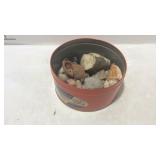 Tin of rocks, nuts, and seashells