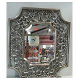 Ornately framed, beveled glass mirror. 27"×31".