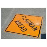 Flag man ahead construction sign