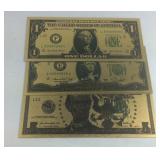 Three goldtone notes $1, $2, $5
