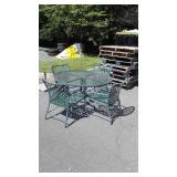 Round glass top patio table and four chairs,