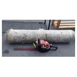 Roll of artificial grass and hedge trimmers
