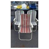 Group of three folding lawn chairs