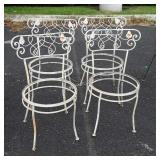Group of four white patio chairs no seats