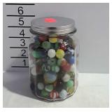 Jar of marbles with some shooters