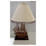 Sailboat design table lamp with fringed shade -