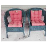 Two wicker patio chairs, with red cushions does