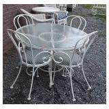 Glass top patio table with four chairs, table is