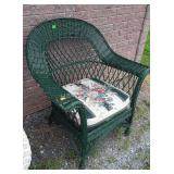 Green wicker patio chair with cushion